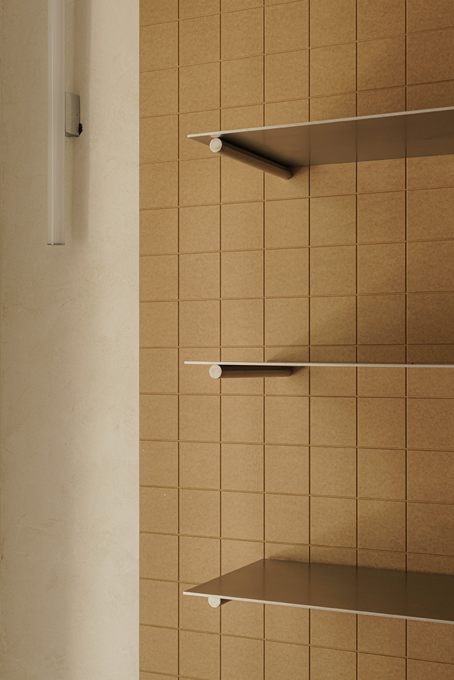 Madreamiga Madrid by estudio DIIR — A close-up detail of the bakery's storage system reveals the material and functional logic of the design.