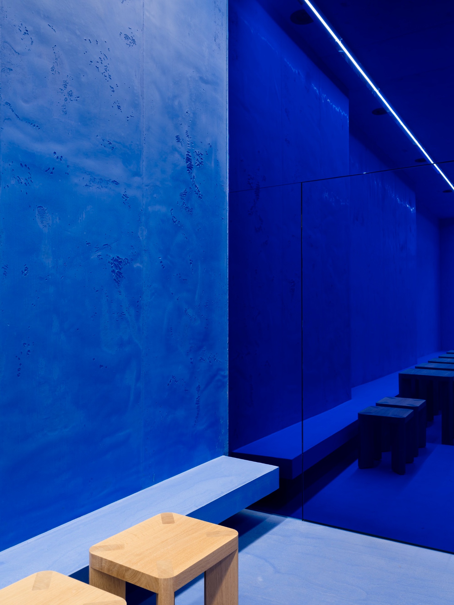 Aera Bakery by Gonzalez Haase AAS — A monochromatic lapis lazuli interior defined by geometric precision and material restraint.