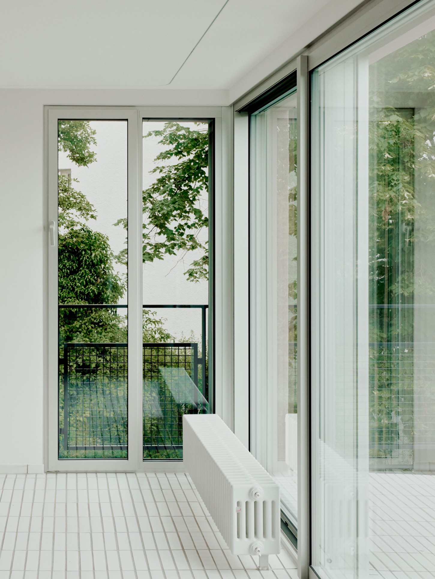 1930’s House Zurich by Ductus by Ductus St — A glazed threshold space frames the 1930s modernist vocabulary through layered fenestration.
