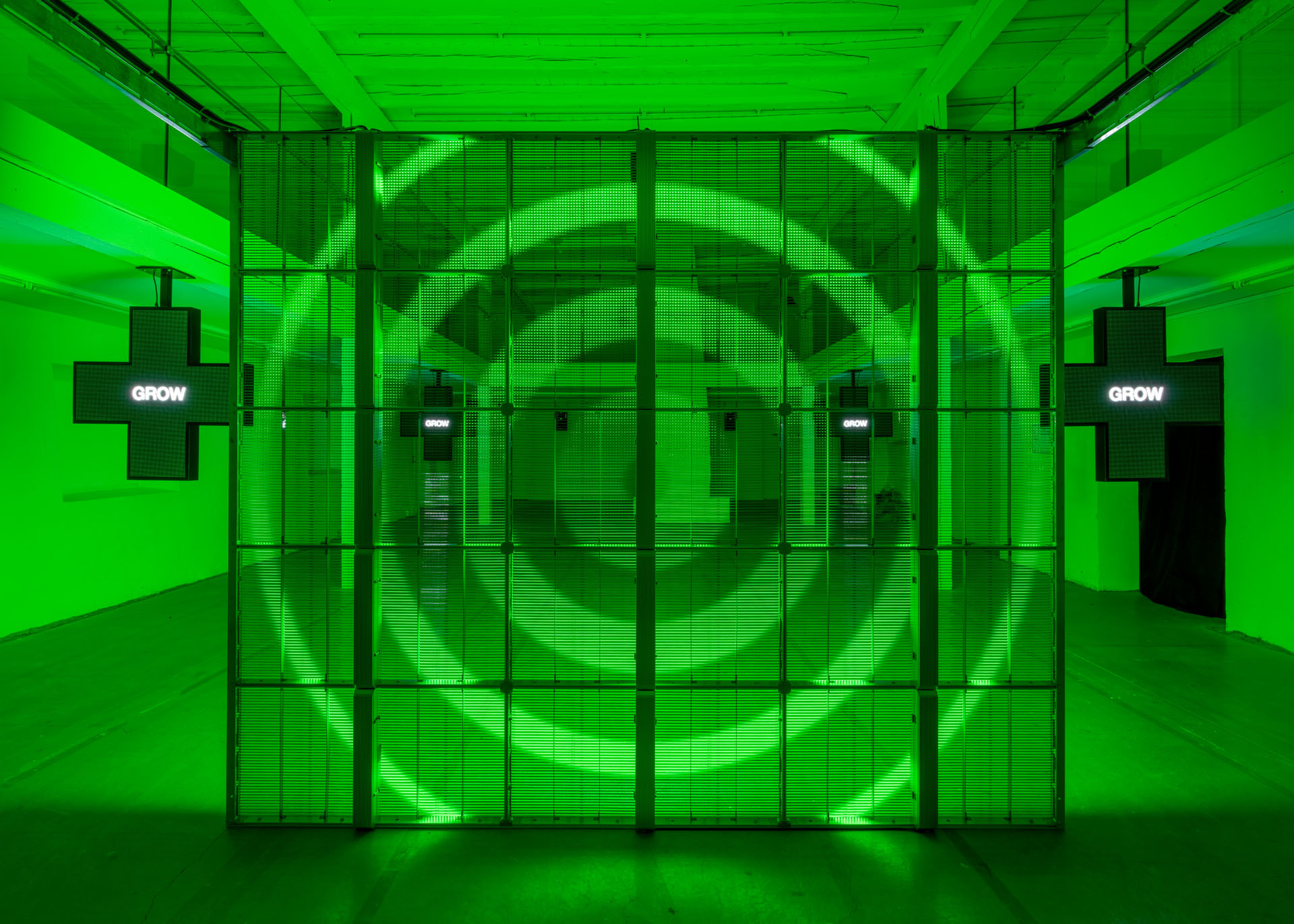 Milk Plus by Jens Settergren Viborg Kunsthal — A monumental LED screen installation dominates the gallery interior, its pixel grid displaying low-resolution green-tinted imagery of organic forms—possibly...