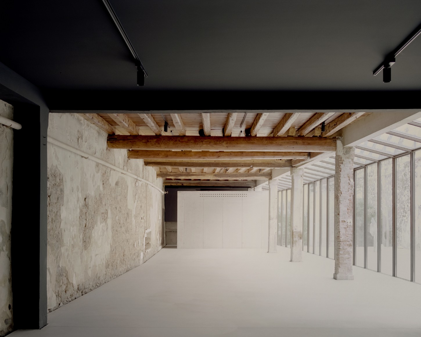 Atipografia Threshold and Treasure Gallery by AMAA — A longitudinal view through the gallery's primary circulation space reveals the structural framework supporting the intervention.