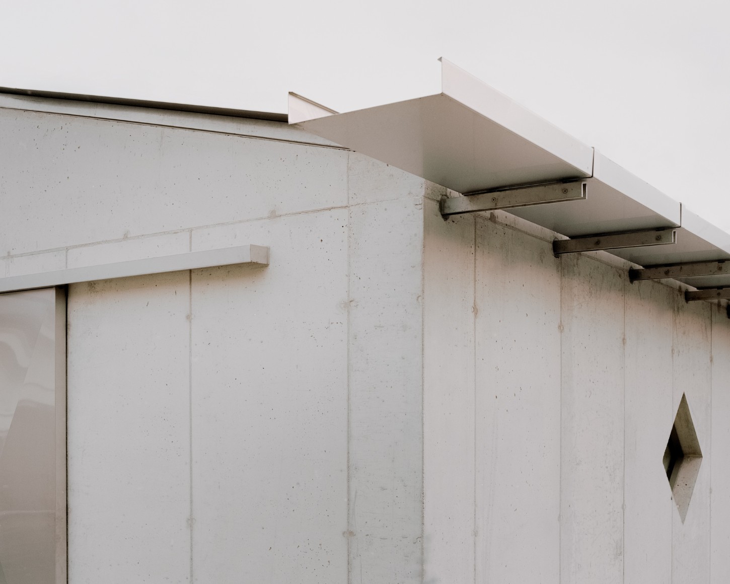 Atipografia Threshold and Treasure Gallery by AMAA — A close-up view of the concrete pavilion's eastern facade reveals the structural vocabulary of AMAA's design.