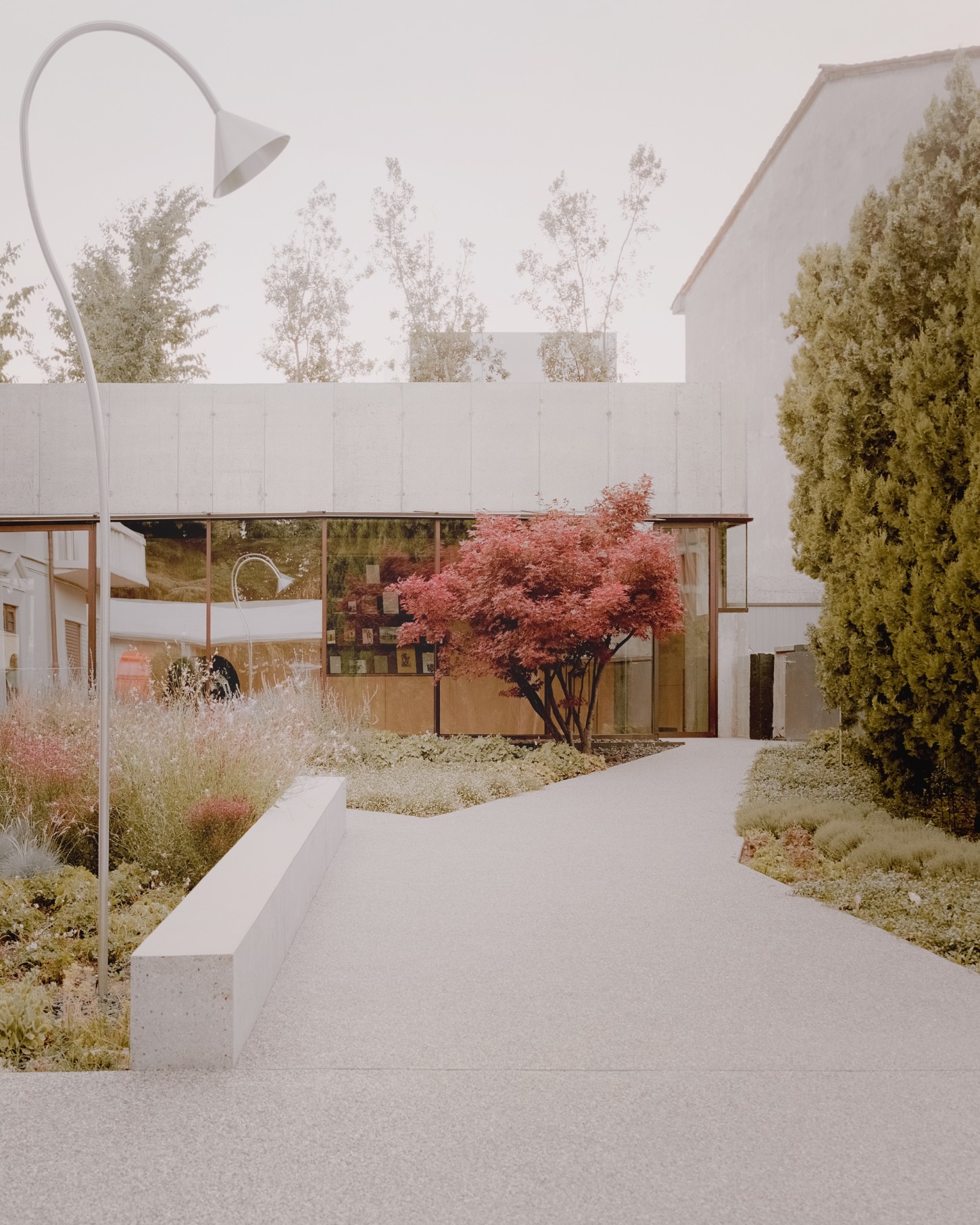 Atipografia Threshold and Treasure Gallery by AMAA — The Atipologia Threshold and Treasure Gallery presents its entry sequence through a monolithic concrete pavilion with cantilevered roof slab extending over...