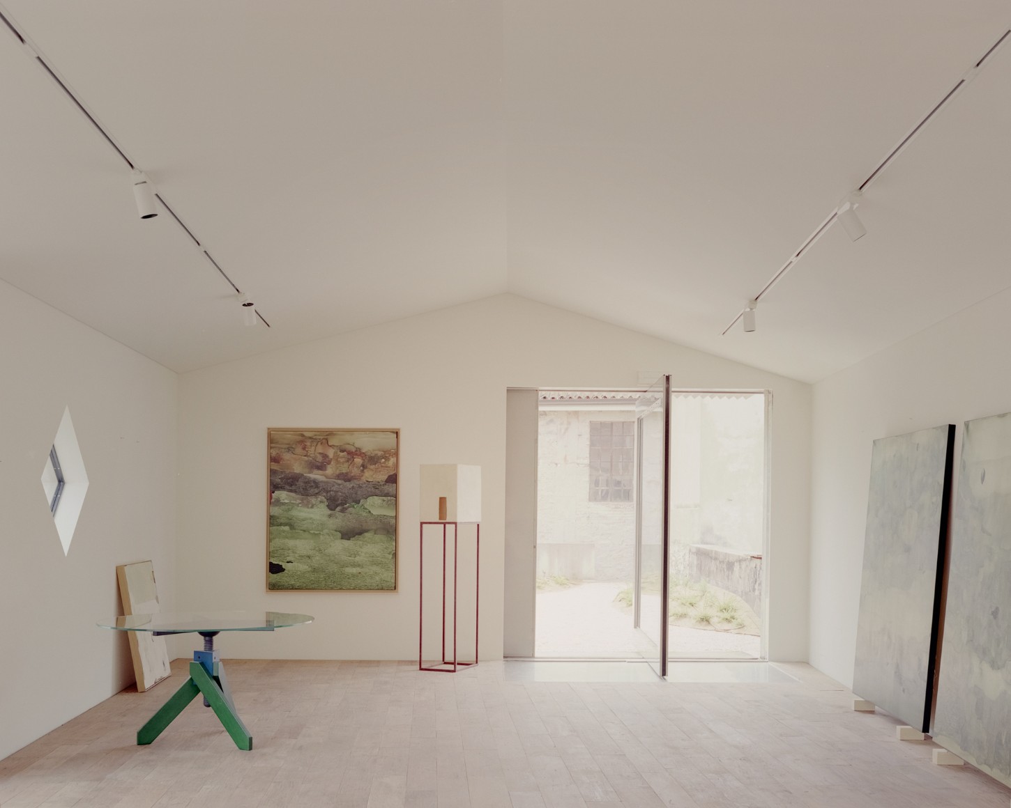 Atipografia Threshold and Treasure Gallery by AMAA — A monolithic concrete pavilion interior in Arzignano reveals a carefully composed gallery space defined by board-formed concrete walls and a cantilevered...