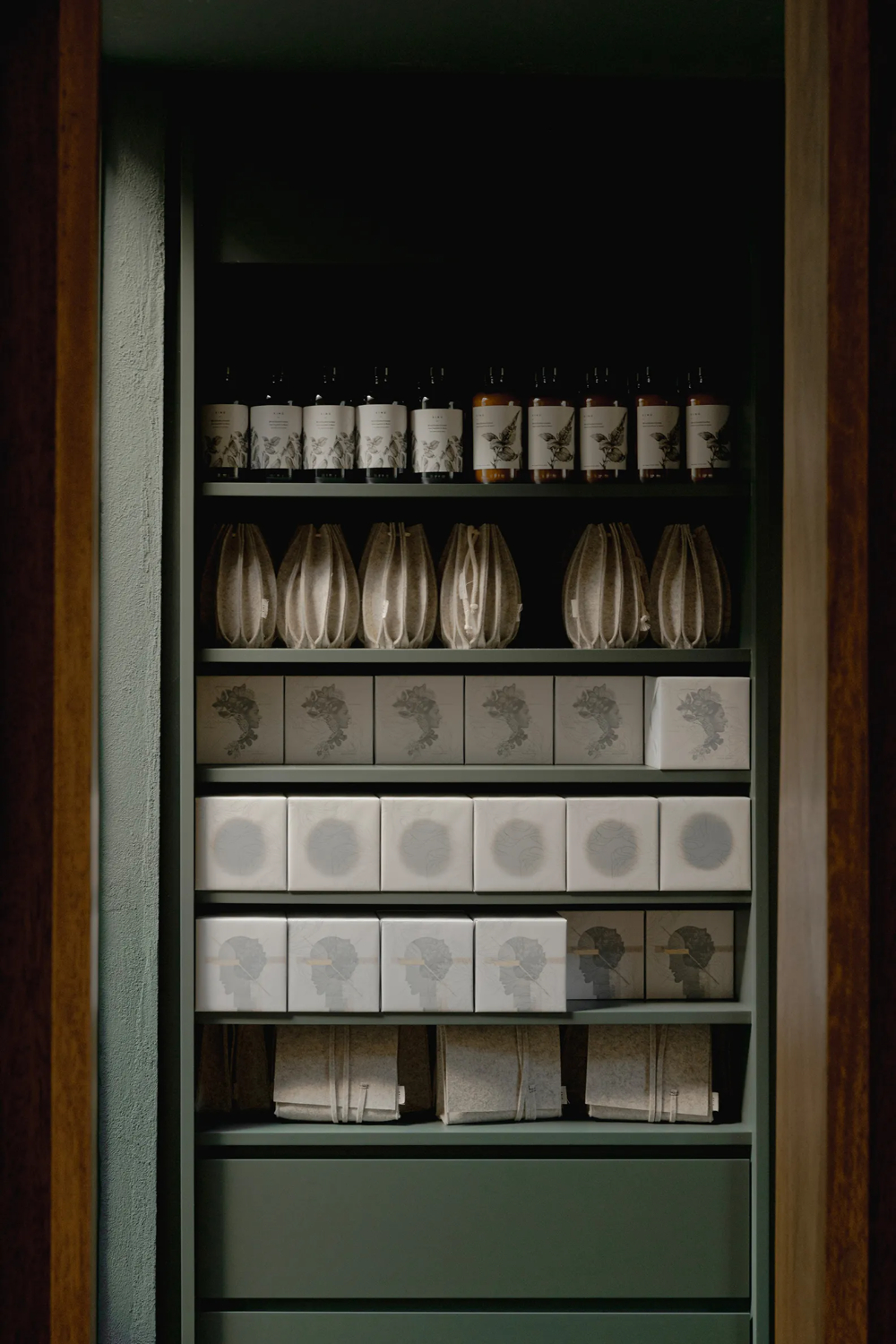 Xinú Marsella by Esrawe Studio by Estrawe Studio — A built-in shelving system displaying Xinú Marsella's retail offerings and sculptural inventory.