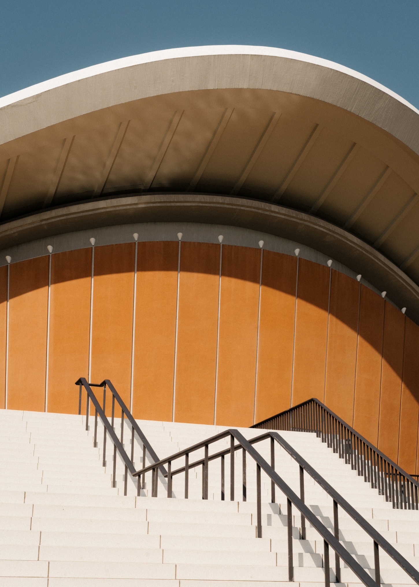 Berlin's Haus der Kulturen der Welt captured by Nate Cook by Hugh Stubbins — A dramatic close-up perspective of the Haus der Kulturen der Welt emphasizes the sculptural shell form through a low-angle view.