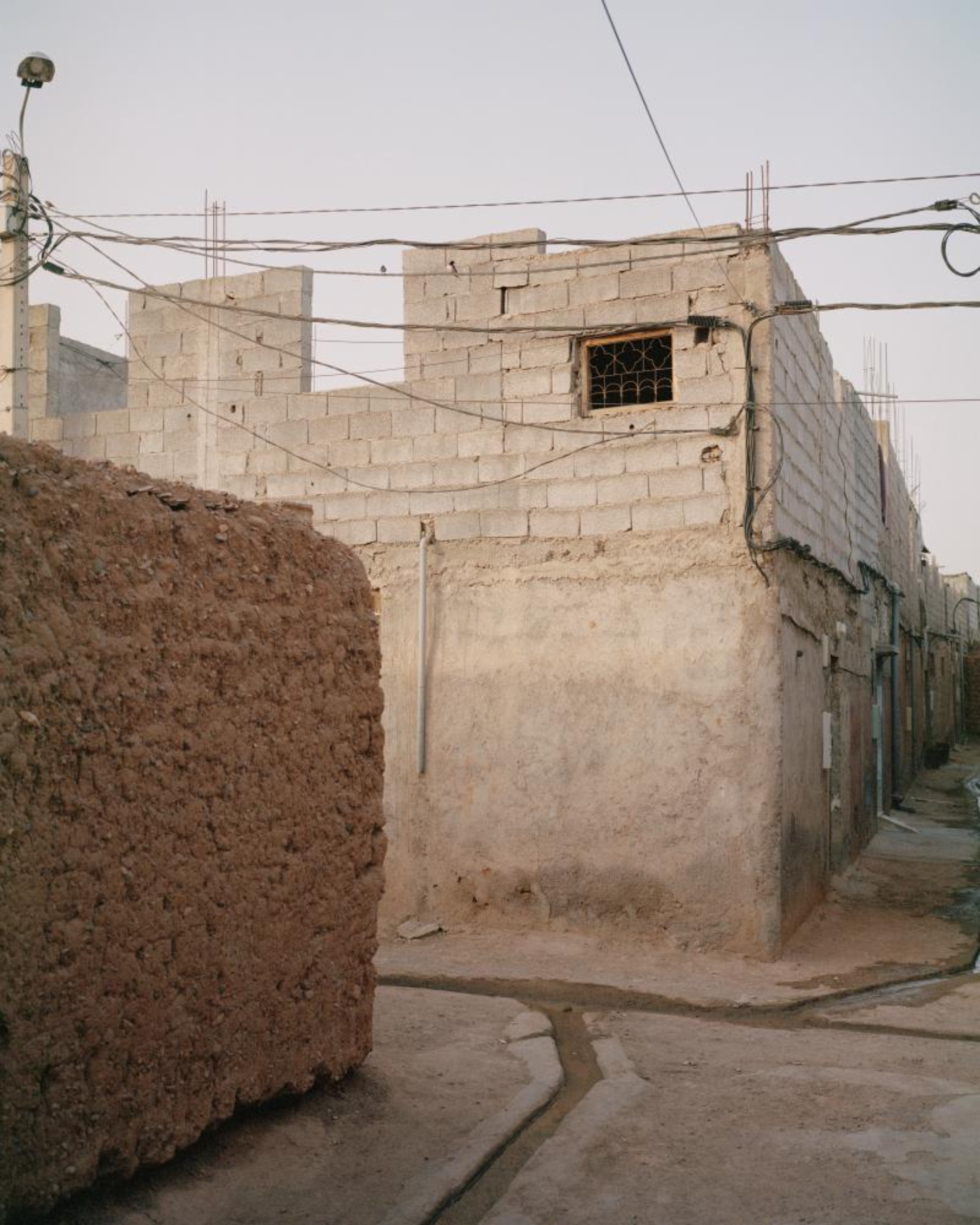 Dar El Farina by Leopold Banchini — A narrow corridor in Dar El Farina reveals the architectural vocabulary of Leopold Banchini's intervention in rural Morocco.