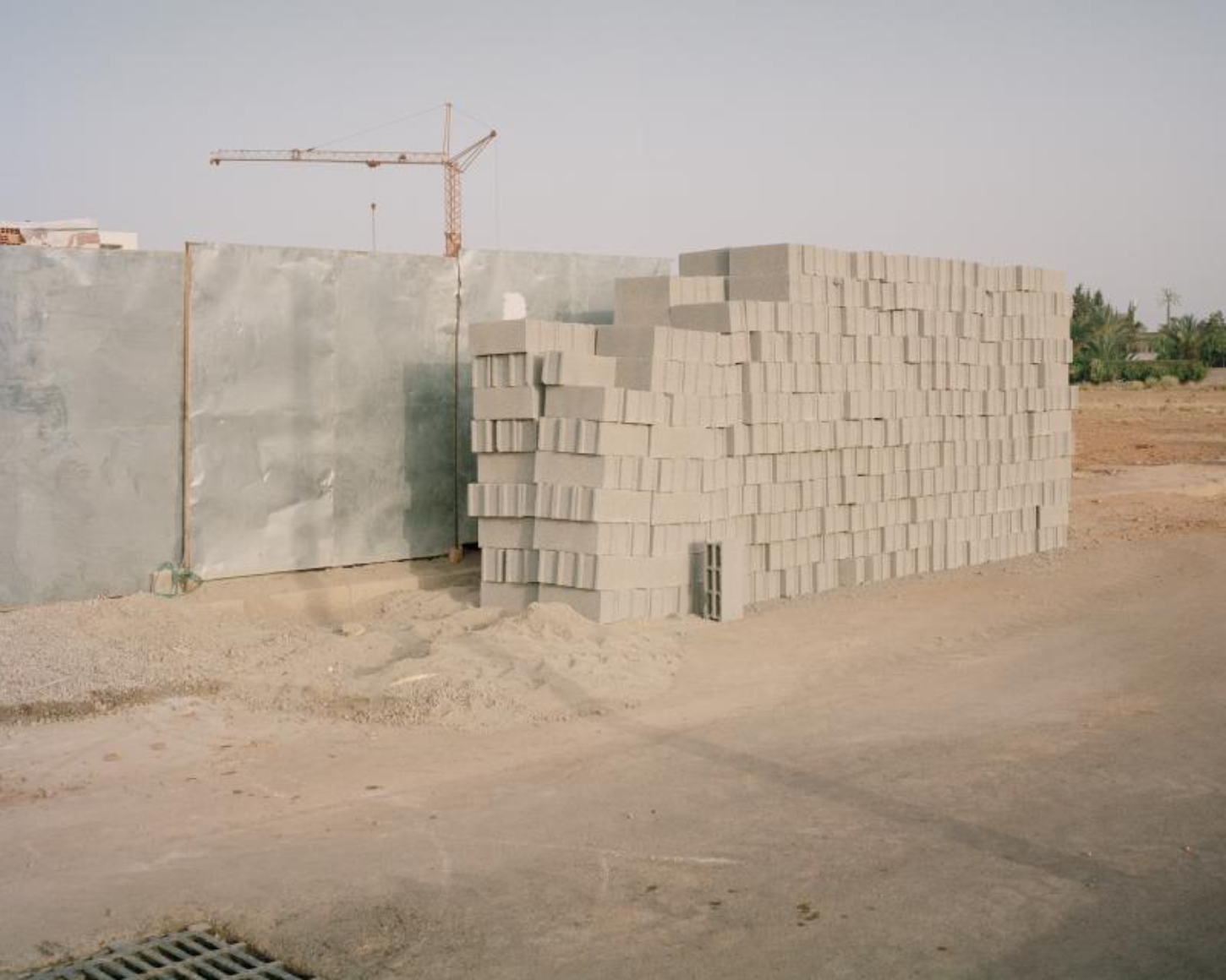 Dar El Farina by Leopold Banchini — A construction-stage photograph documenting the perforated concrete-block envelope of Dar El Farina.
