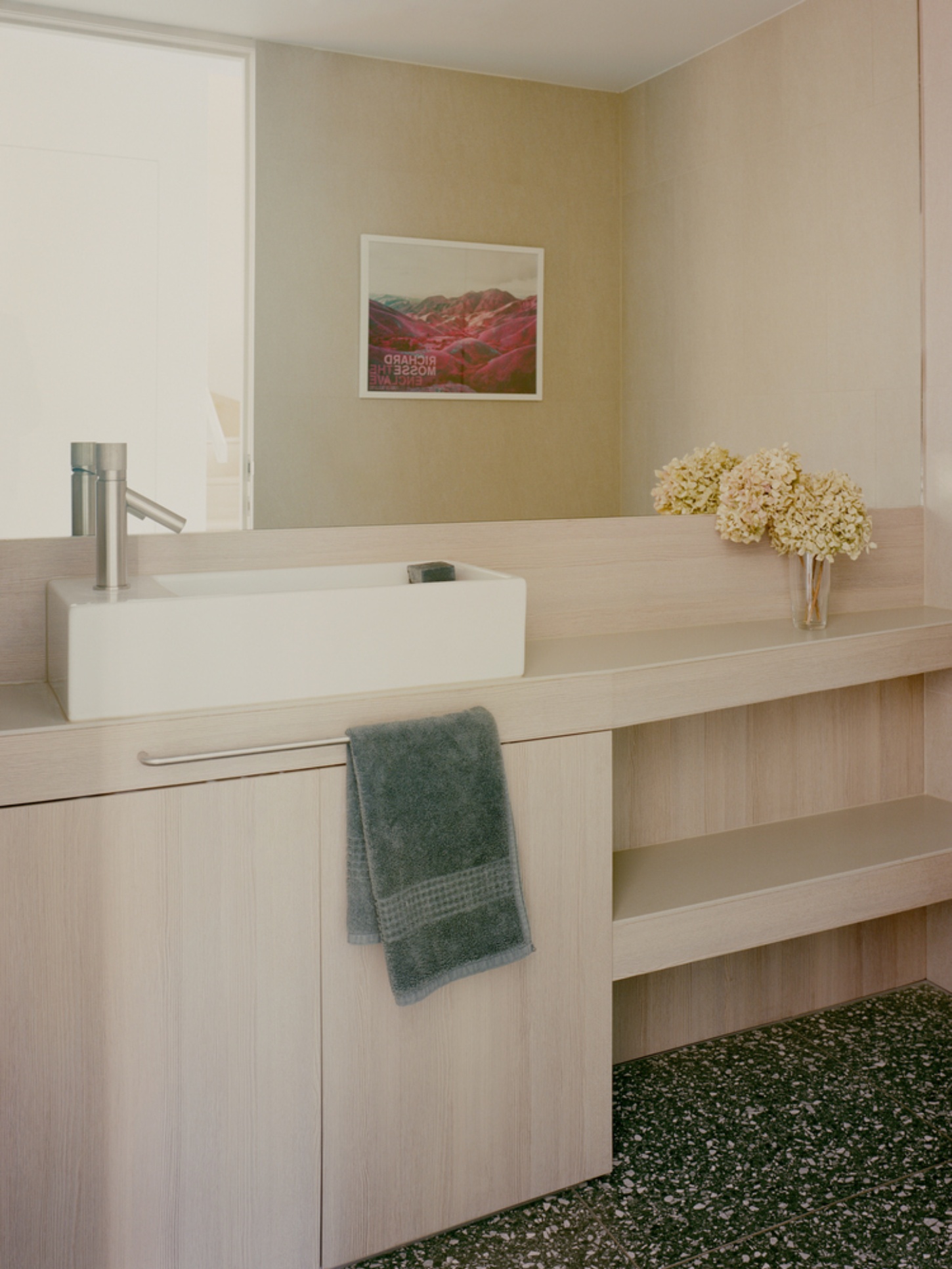 Garden Wall House by Sonelo Architects — A bathroom vanity in light timber with an integrated white ceramic vessel sink and brushed steel faucet.
