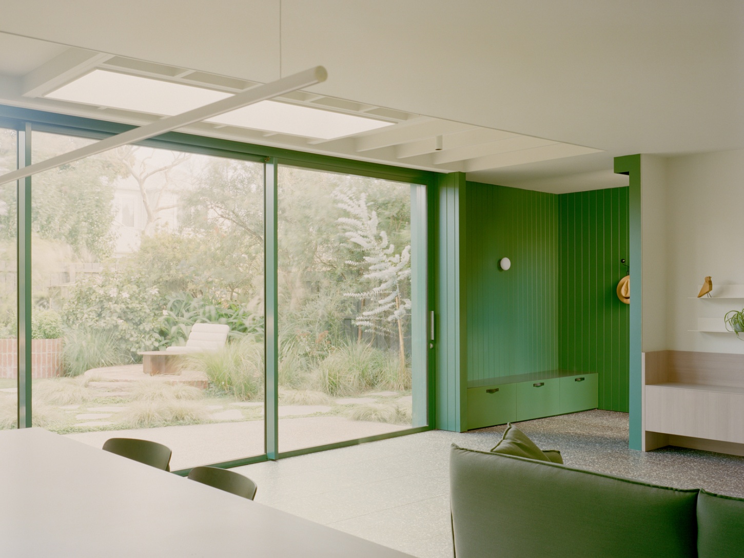 Garden Wall House by Sonelo Architects — A south-facing living space transformed through expansive glazing and strategic color.