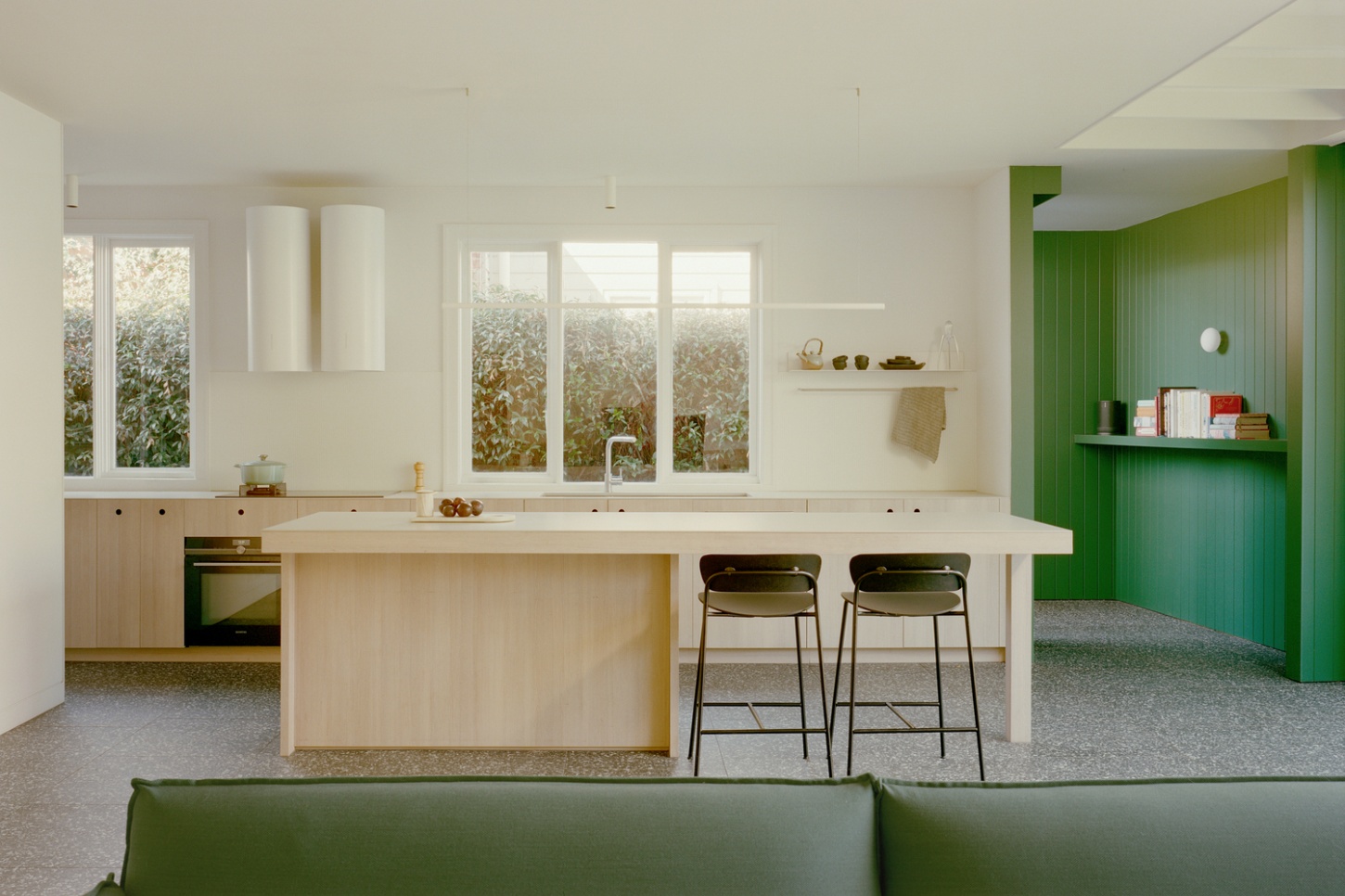 Garden Wall House by Sonelo Architects — The kitchen interior showcases a deliberate material and color strategy across interconnected spaces.