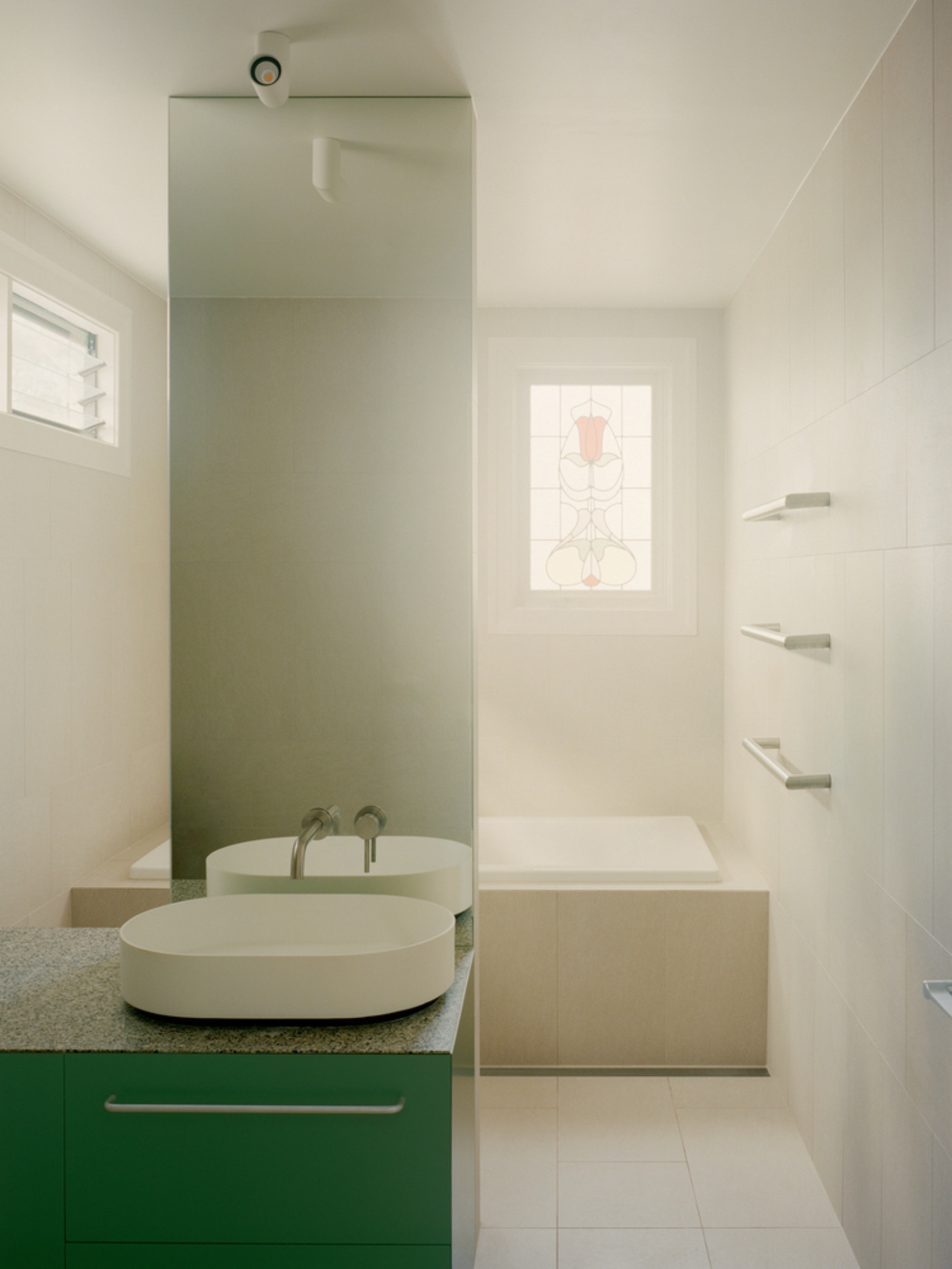 Garden Wall House by Sonelo Architects — The ensuite bathroom exemplifies the Garden Wall House's material restraint and functional clarity.