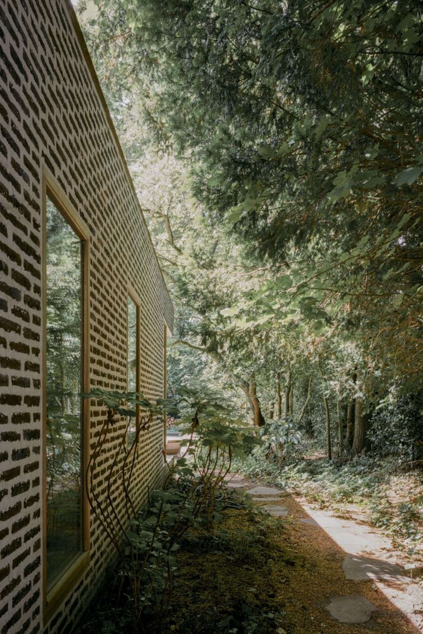BD House by Space Encounters + Studio Vincent Architecture — A narrow garden passage frames the renovation's threshold between old and new.