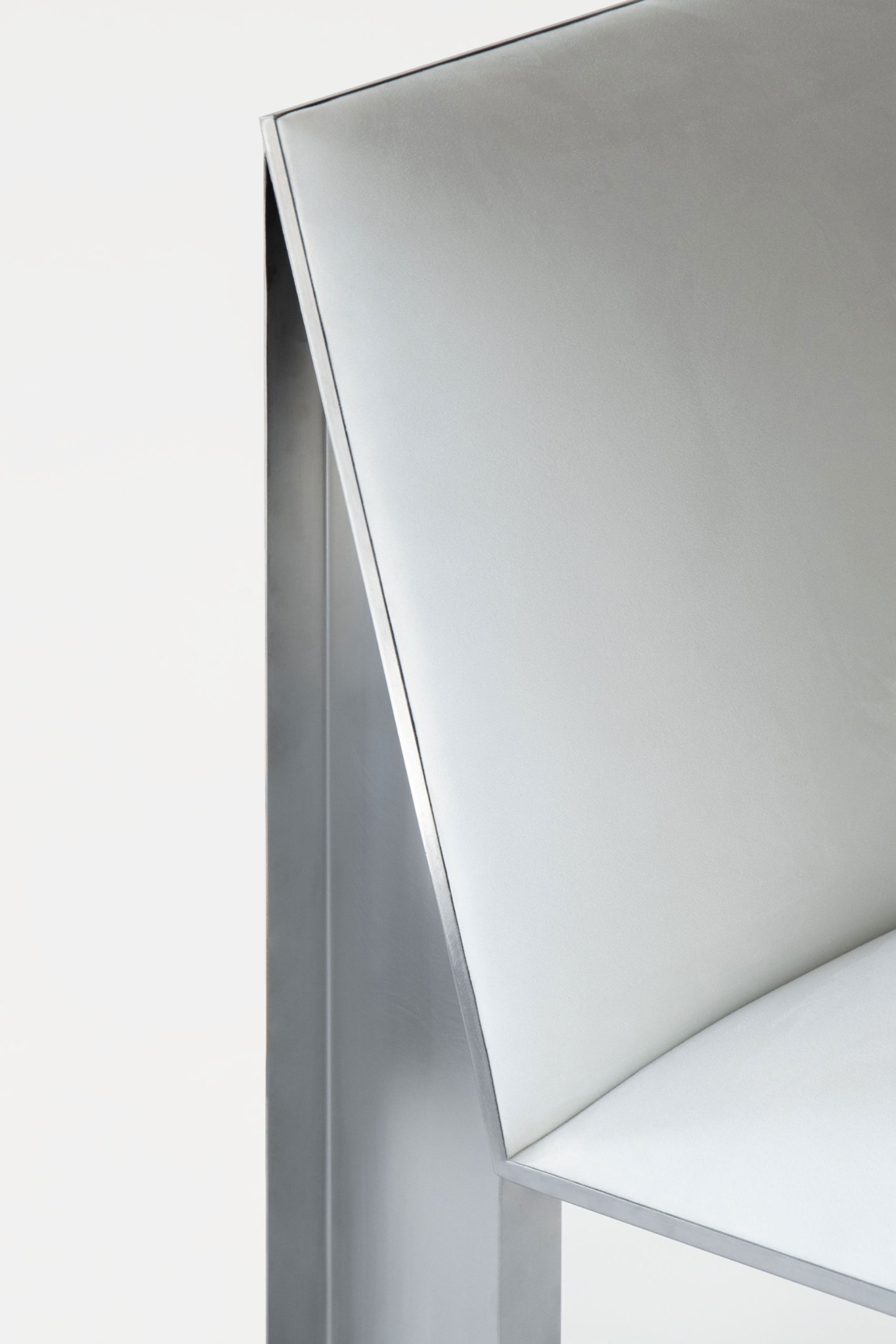 Ele Armchair by Jaume Ramirez Studio — Close-up detail of the Ele Armchair's junction between tubular metal frame and upholstered form.