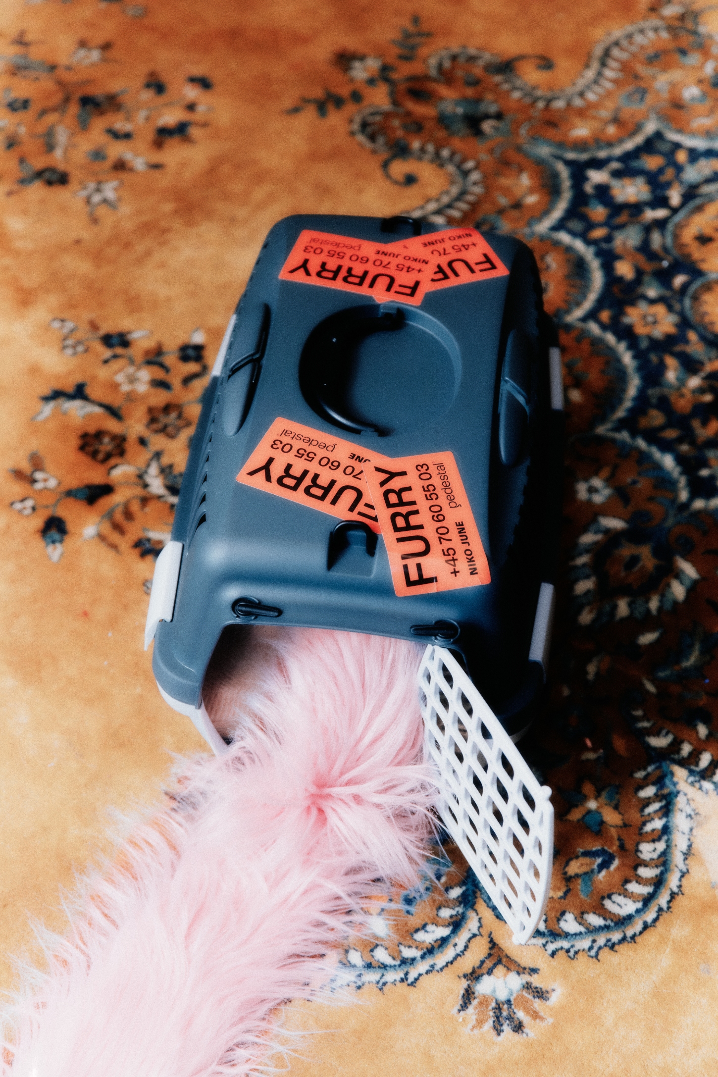 FURRY by Pedestal x NIKO JUNE — A FUR-wrapped power strip photographed from above against a patterned textile background.
