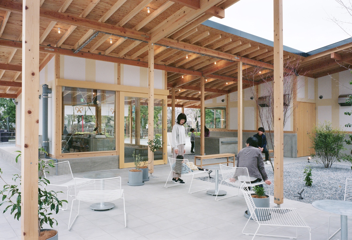 Funamachi Base Store by Jo Nagasaka + Schemata Architects — A covered courtyard pavilion with exposed timber post-and-beam construction creates a semi-enclosed gathering space.
