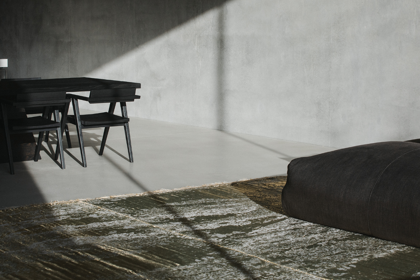 Villa Mahler by Anna Philipp + Eichkorn — A sparsely furnished interior corridor bathed in directional sunlight that casts sharp geometric shadows across the polished concrete floor.