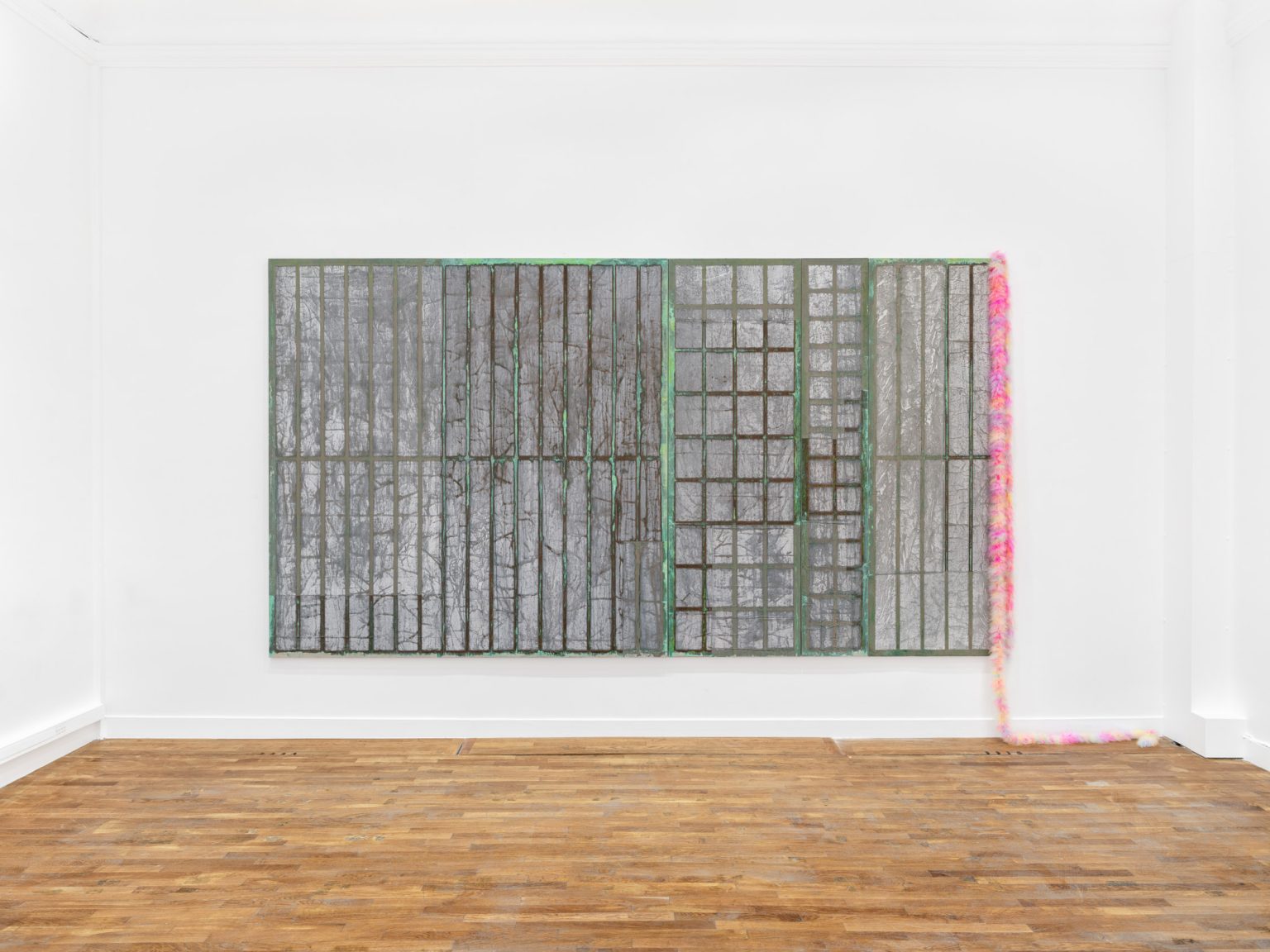 Lies by Mimosa Echard at Galerie Chantal Crousel — A horizontal mixed-media work spanning the gallery wall combines oxidized metallic panels with embedded photographic documentation of Paris's 1920s arcade...