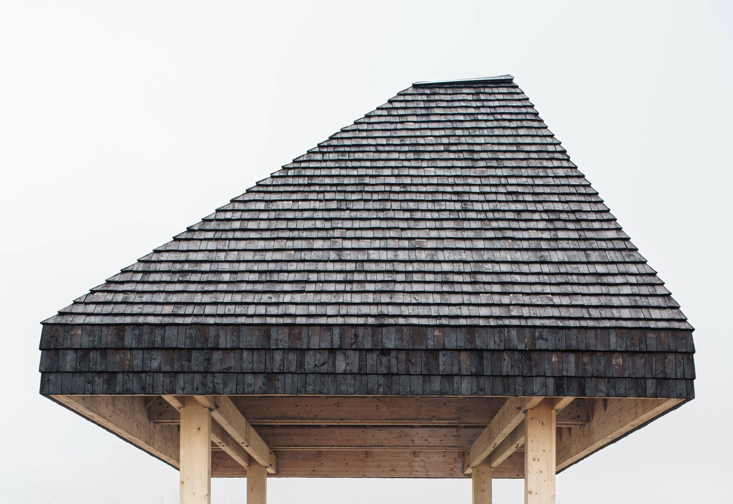 Amager Nature Park by ADEPT and LYTT Architecture — A conical pavilion structure elevated on wooden piling demonstrates restraint through geometric simplicity.