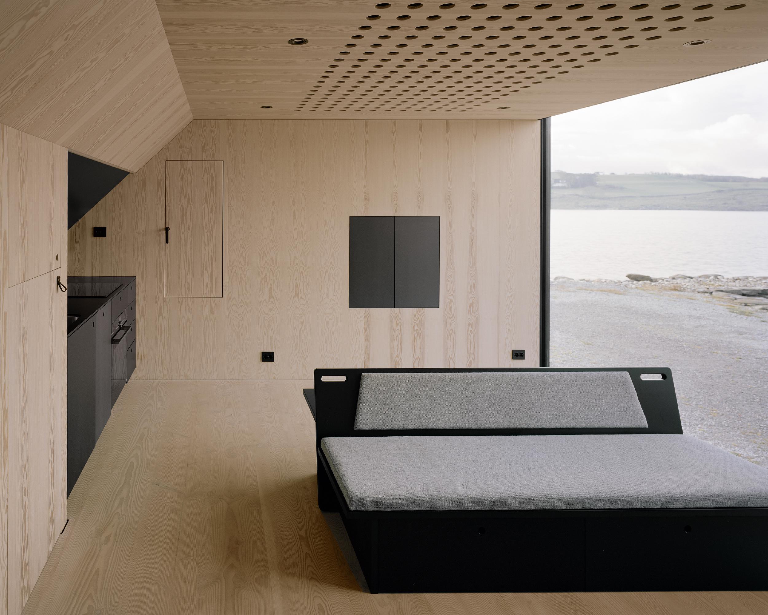 Boat House (Naust) by Espen Surnevik — Interior view of the boathouse showing the minimalist intervention within the timber-clad structure.
