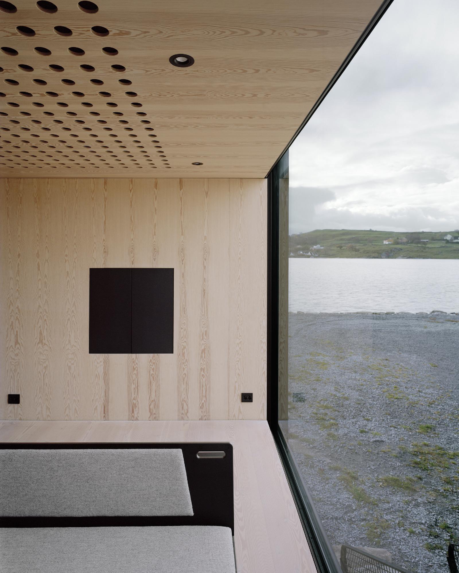 Boat House (Naust) by Espen Surnevik — Interior view of the boathouse's minimalist upper structure, framed by a continuous horizontal window overlooking Sokn's coastal landscape.