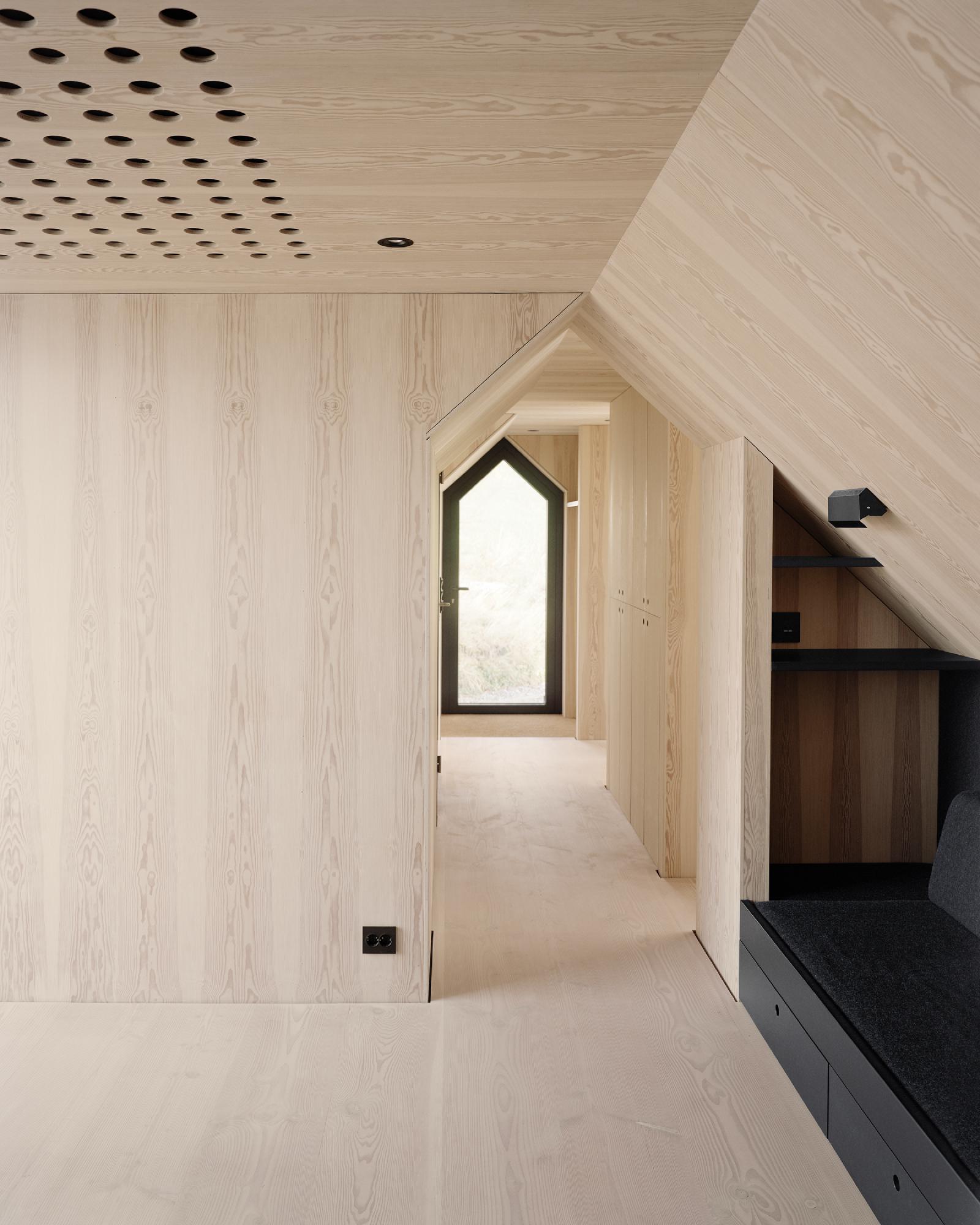 Boat House (Naust) by Espen Surnevik — Interior passage within the renovated boathouse reveals the layered material strategy defining Surnevik's intervention.