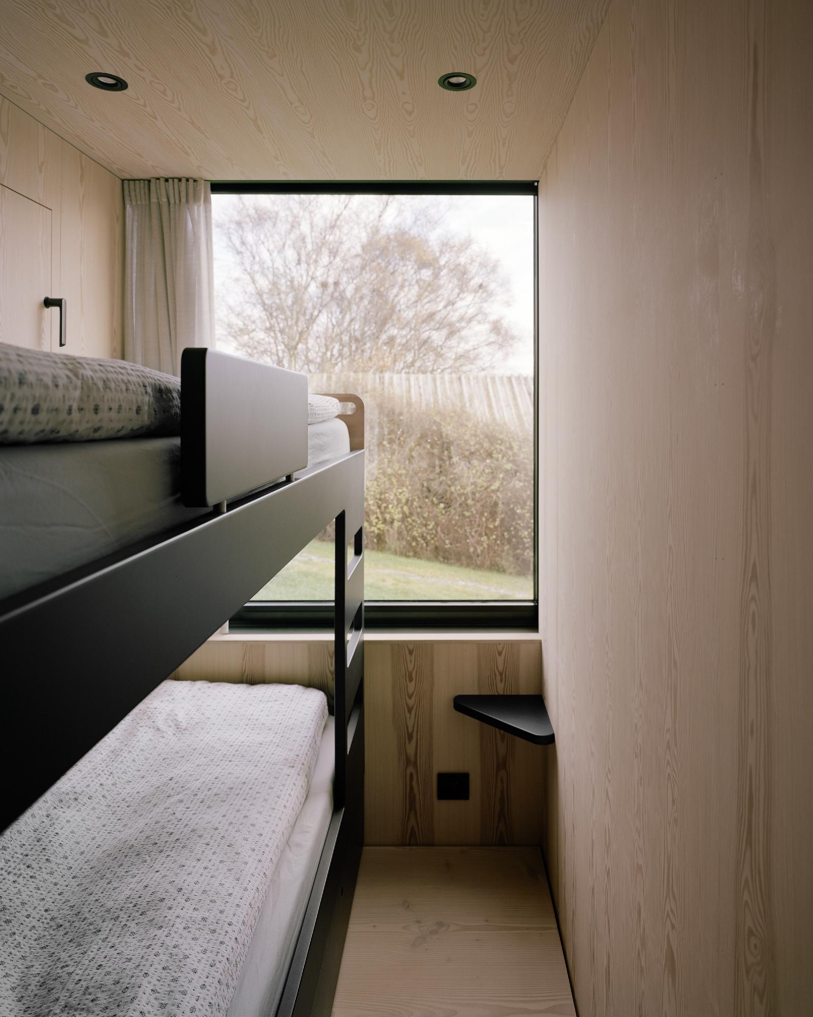 Boat House (Naust) by Espen Surnevik — A narrow sleeping quarters reveals the boathouse's dual material vocabulary.