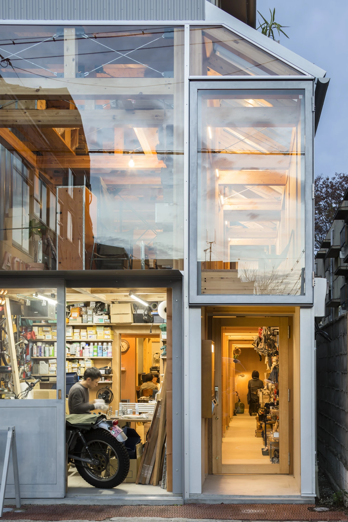House A/Shop B (Bolts Hardware Store) by KimuraMatsumoto Architects — A narrow storefront in Kyoto's dense urban fabric displays the working interior of a hardware store through full-height glazing.