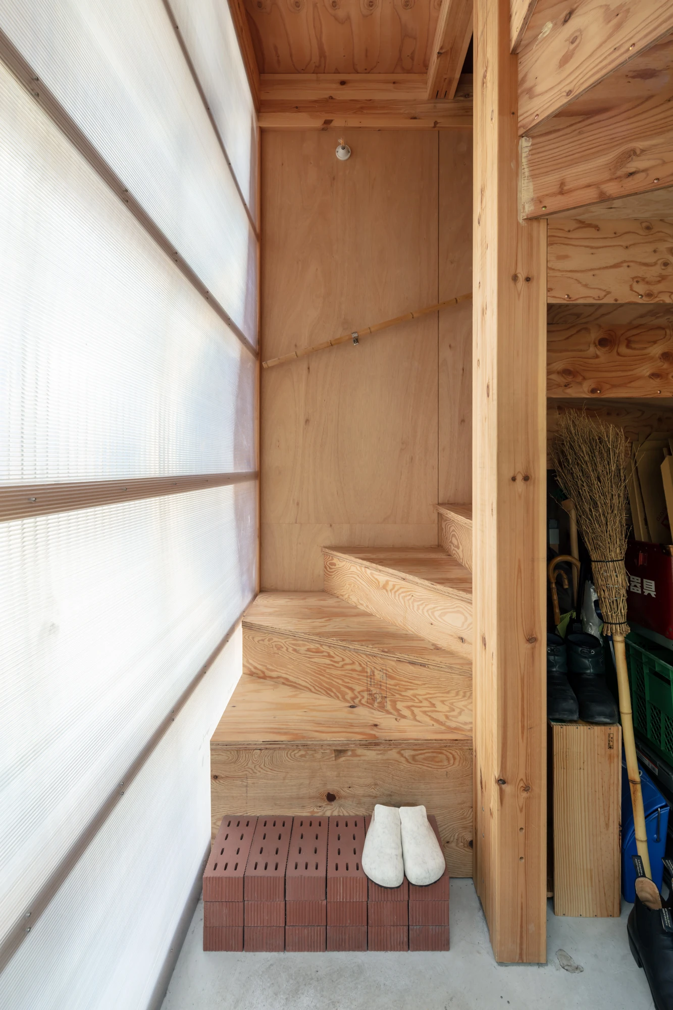 House S/Shop B (ba hütte) by KimuraMatsumoto Architects — Interior threshold of ba hütte showing the narrow entrance passage that mediates between street and interior space.