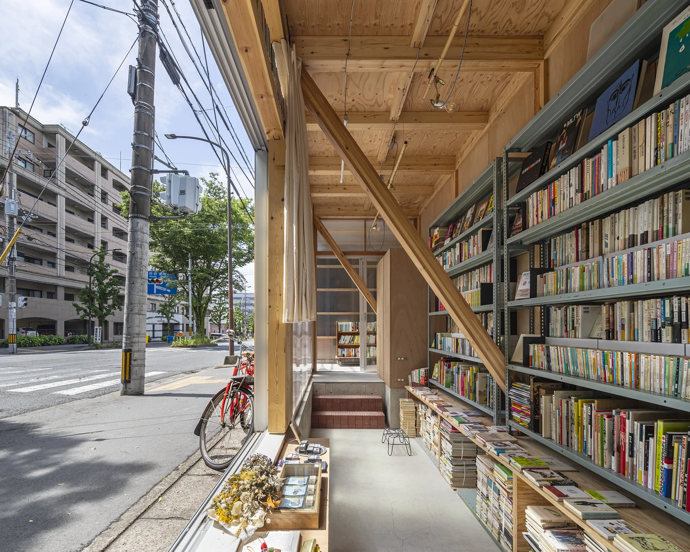 House S/Shop B (ba hütte) by KimuraMatsumoto Architects — A narrow street-facing library interior captures the fluid boundary between Kyoto's public sidewalk and private retail space.