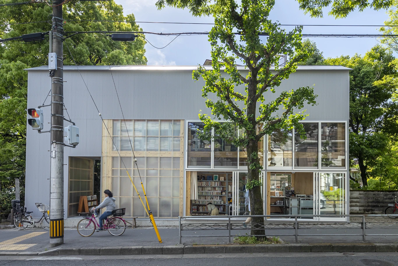 House S/Shop B (ba hütte) by KimuraMatsumoto Architects — Street-facing facade of a narrow commercial-residential structure with corrugated metal cladding in grey.
