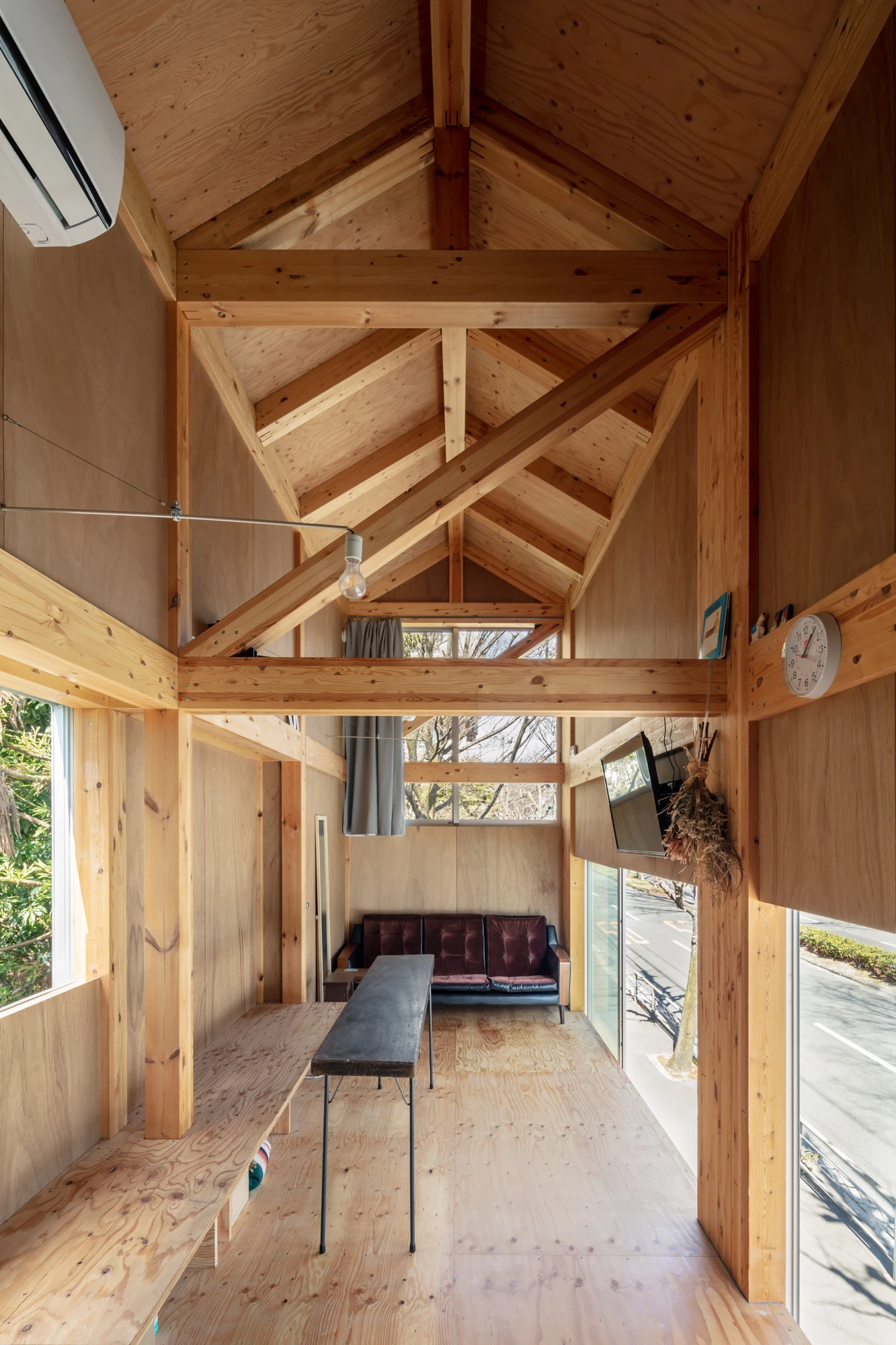 House S/Shop B (ba hütte) by KimuraMatsumoto Architects — Interior view of a timber-frame structure with exposed post-and-beam construction throughout.