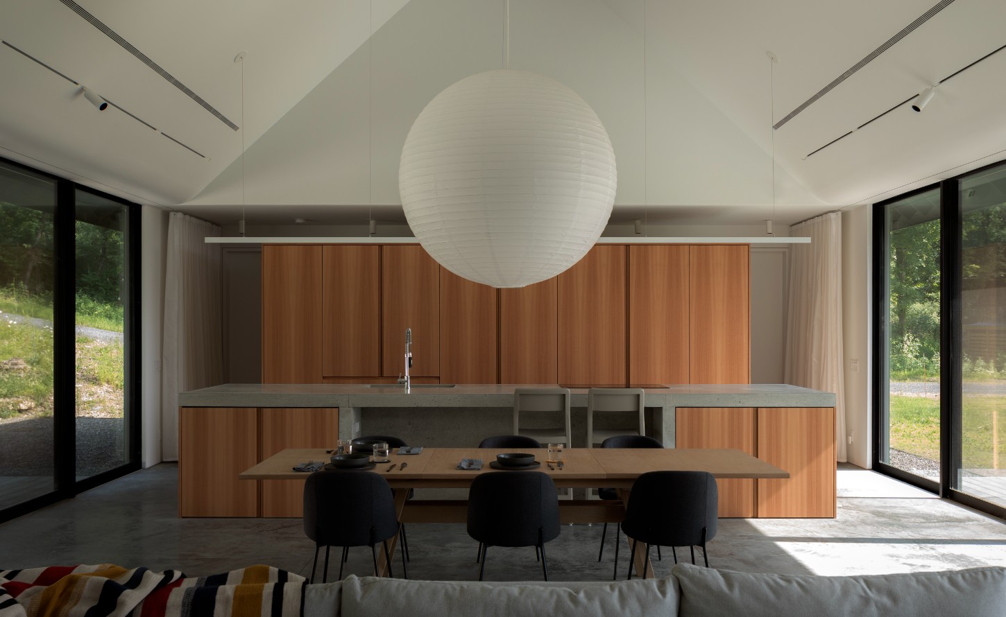 House in a Meadow by Group Projects Architecture — Interior view of the open-plan kitchen and dining area demonstrates the generous spatial organization and material palette of House in a Meadow.