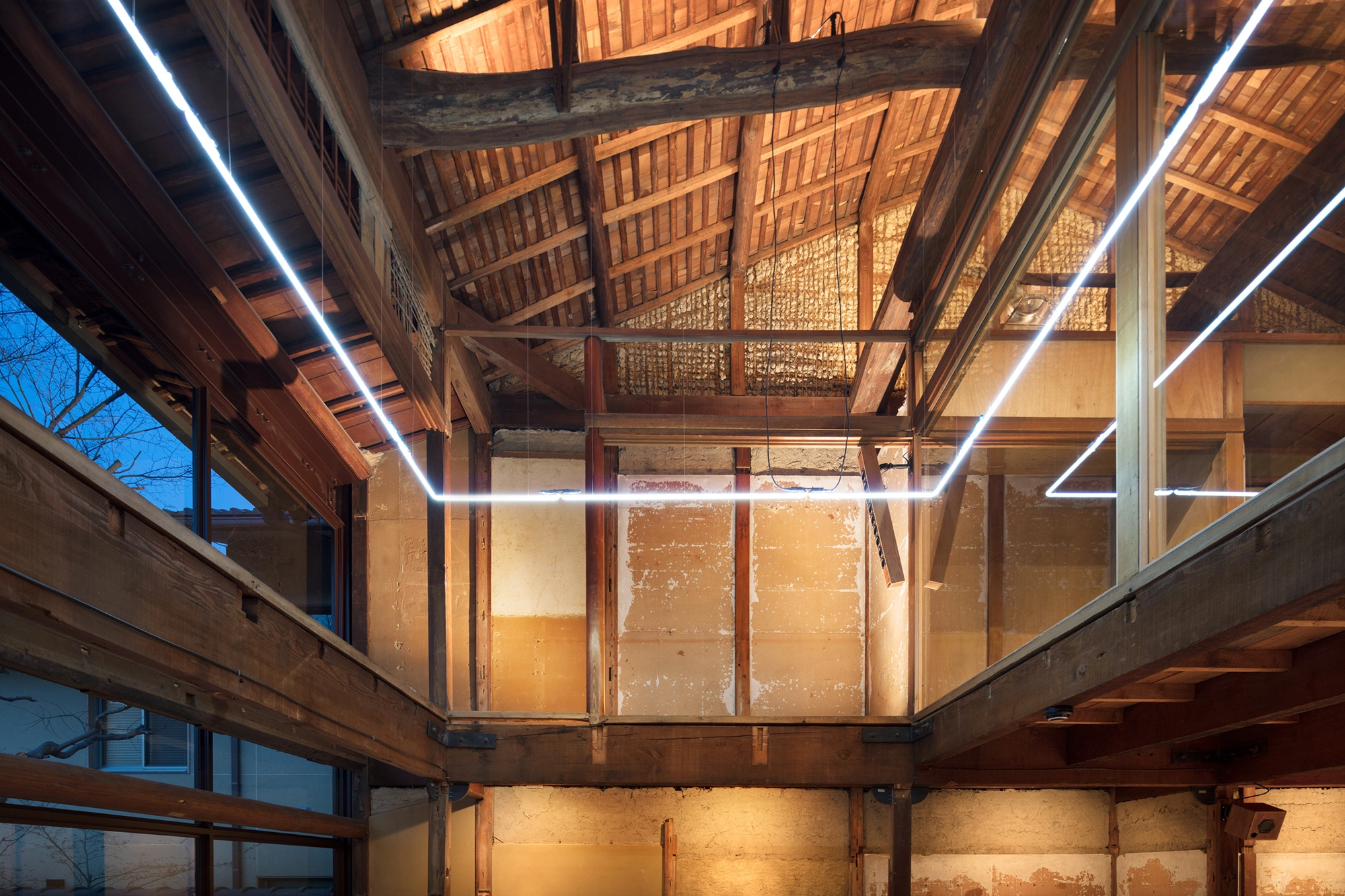 Blue Bottle Coffee Kyoto Cafe by Schemata Architects — Viewed from within the café's interior, this photograph captures the ceiling architecture as the primary compositional focus.