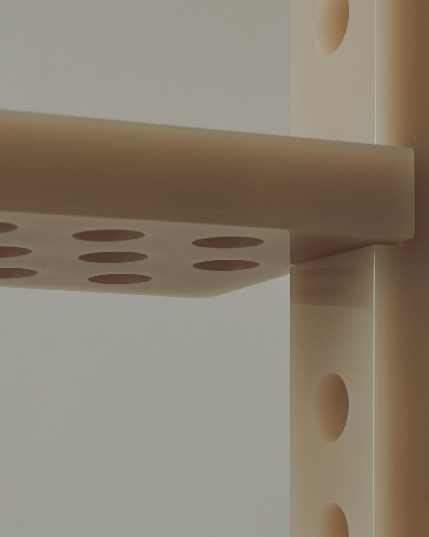 Selected Works by Forever Studio — A close-up view of a timber shelving or storage system designed by Forever Studio, featuring precisely drilled circular perforations arranged in a regular...