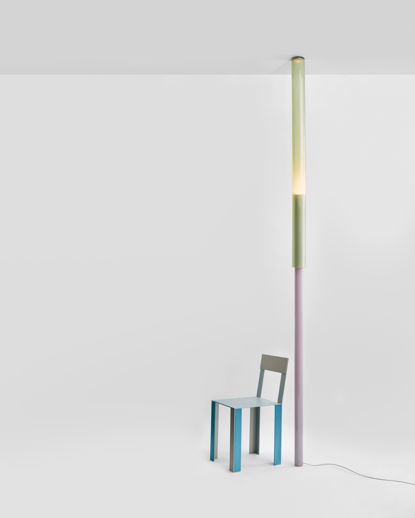 Selected Works by Forever Studio — A tall cylindrical floor lamp with a segmented structure anchors a minimal composition.