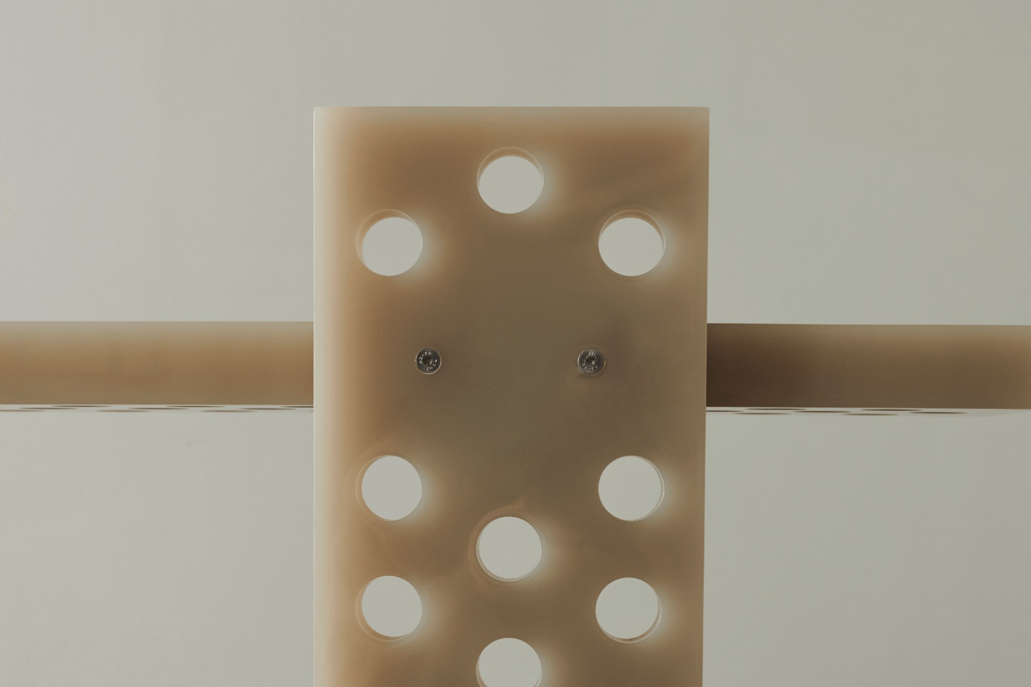 Selected Works by Forever Studio — A timber panel mounted horizontally between two wooden beams demonstrates precision manufacturing through a grid of regularly-spaced circular perforations.