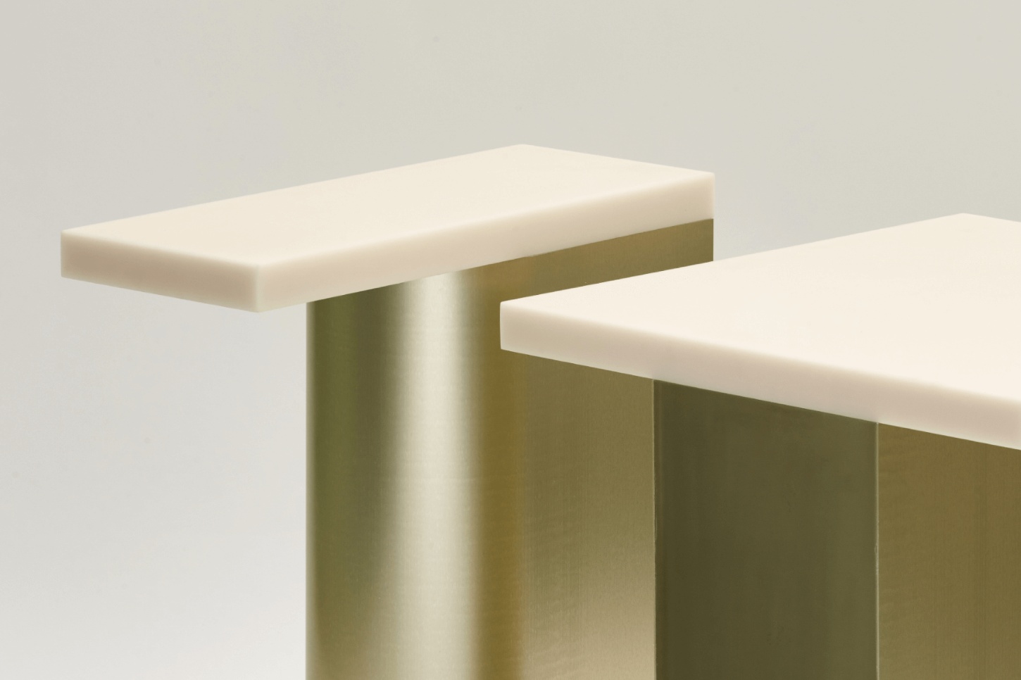 Selected Works by Forever Studio — Two cantilevered surfaces with cream-colored tops extend from a central brass-toned support structure.
