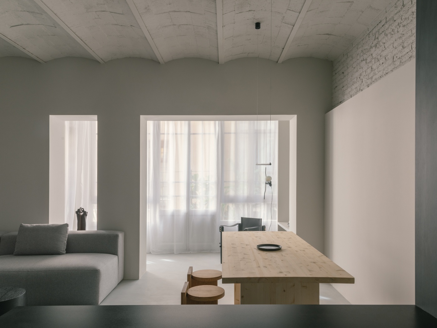 Casa Norte by CORREA Studio — A dining threshold framing the unified living zone beyond.