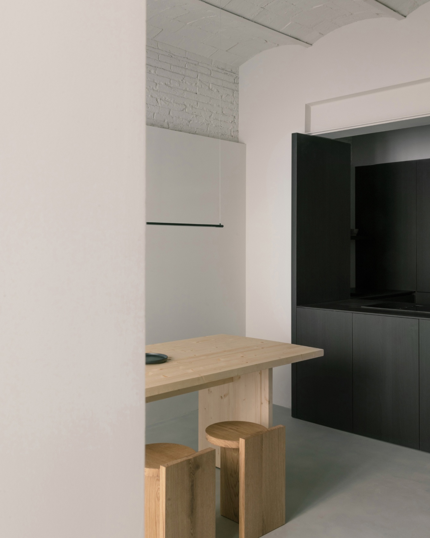Casa Norte by CORREA Studio — A corner nook anchors the open-plan reorganization, showcasing the material dialogue between warm and cool tones.