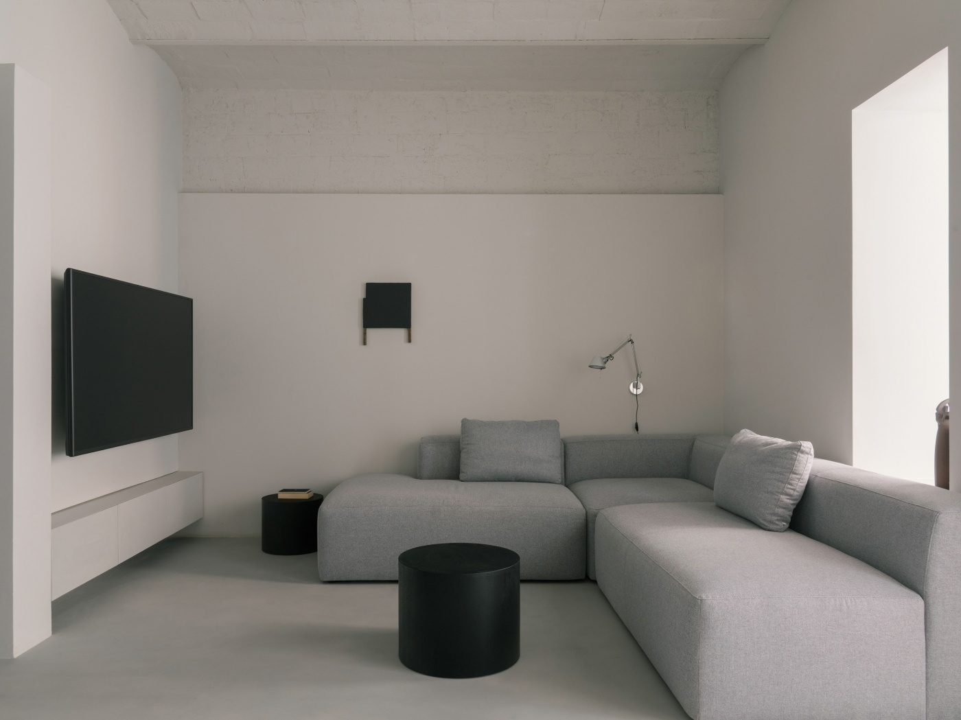 Casa Norte by CORREA Studio — A minimalist living room rendered in a restrained palette of grey, white, and black.