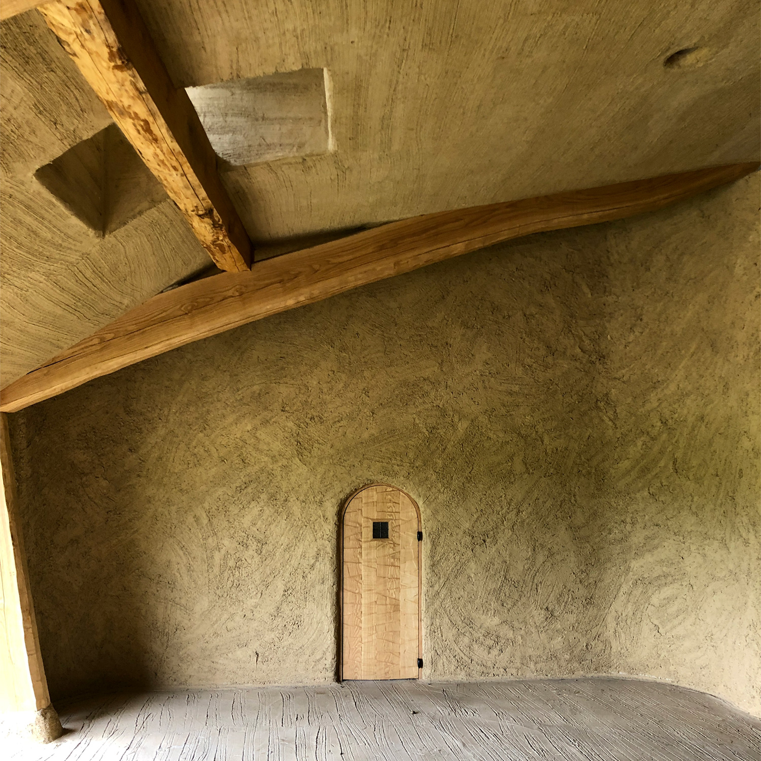 La Collina Ōmi-Hachiman by Terunobu Fujimori + Michele De Lucchi — Interior passage with vaulted timber ceiling and exposed beam structure overhead.