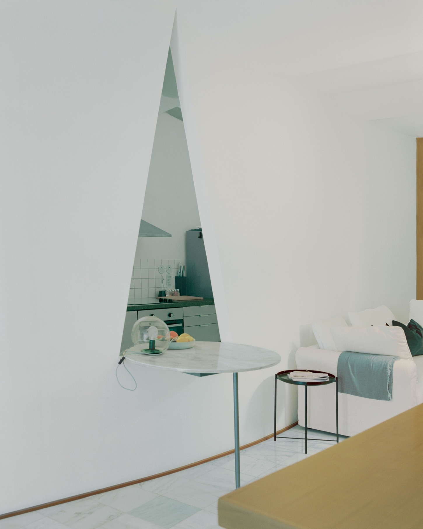 'Fireworks in White' by Willem Pab — A monolithic glass-block partition wall defines this compact residential alcove, its grid pattern creating translucent separation between living and kitchen...