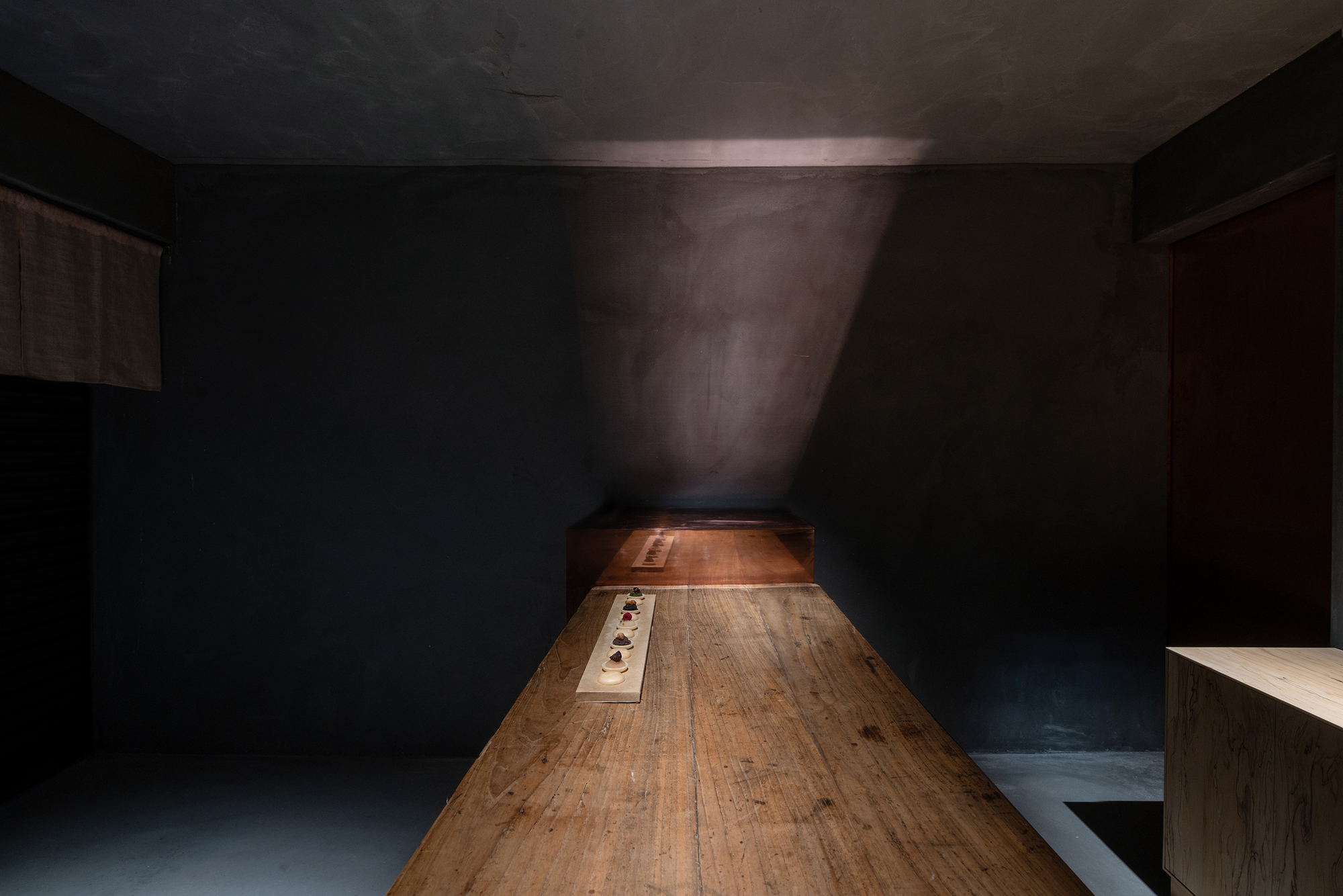 mitomi by Koyori + Aterier Salt — A linear perspective through a narrow interior corridor reveals the spatial compression characteristic of mitomi's tea house-inspired design.