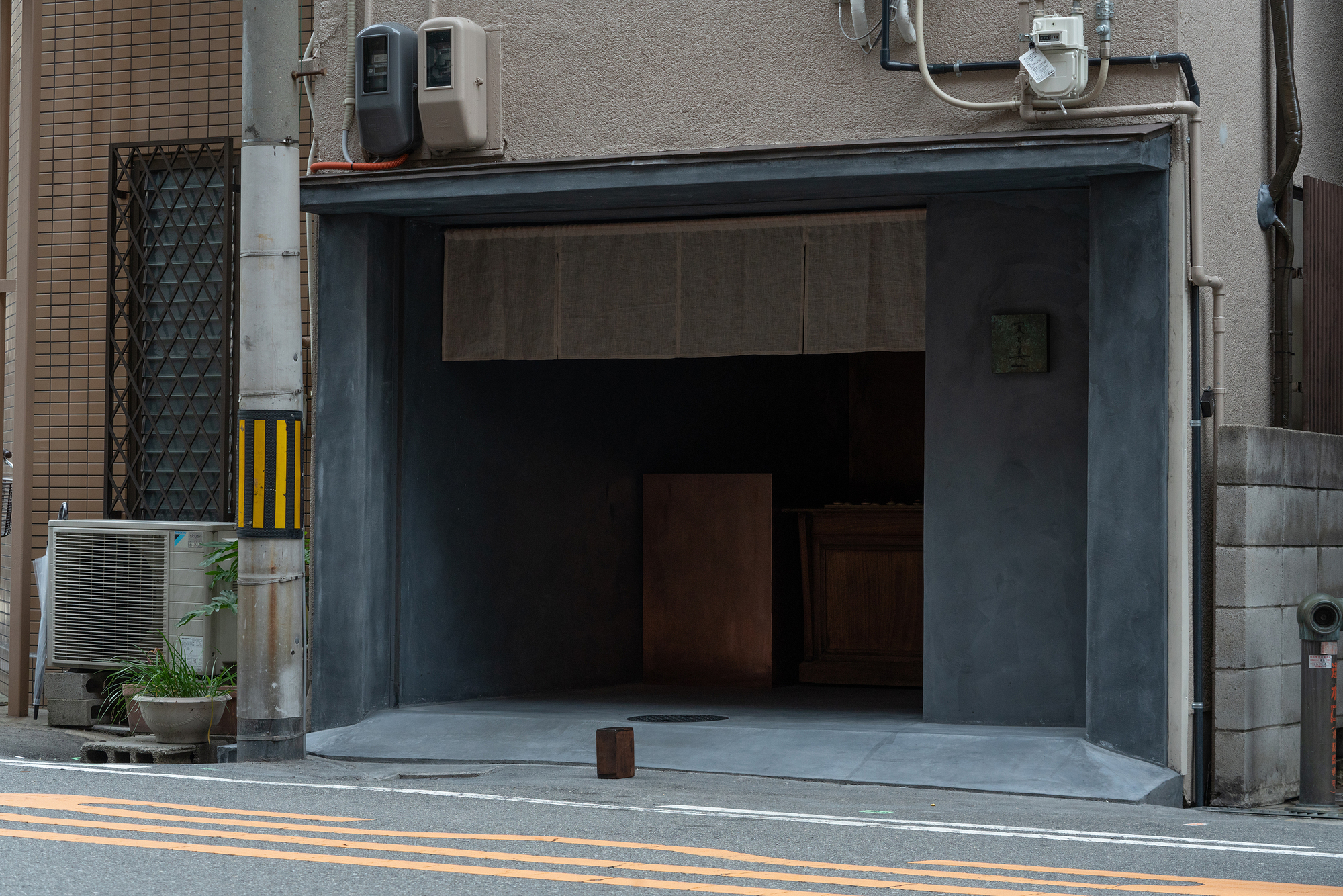 mitomi by Koyori + Aterier Salt — The storefront presents a dramatic threshold between street and interior.