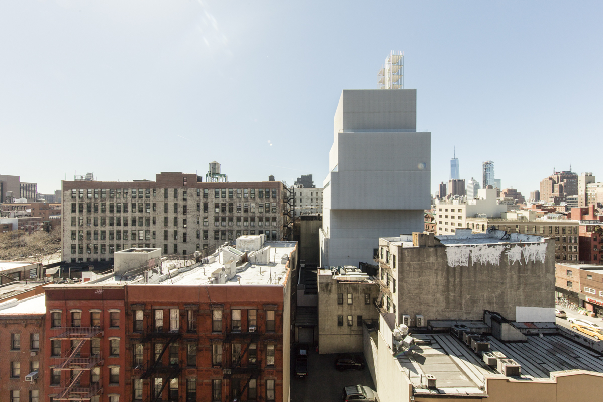 New Art Museum by SANAA — The New Art Museum's stacked volumetric form dominates this street-level perspective, its white rendered facade creating stark contrast against the...