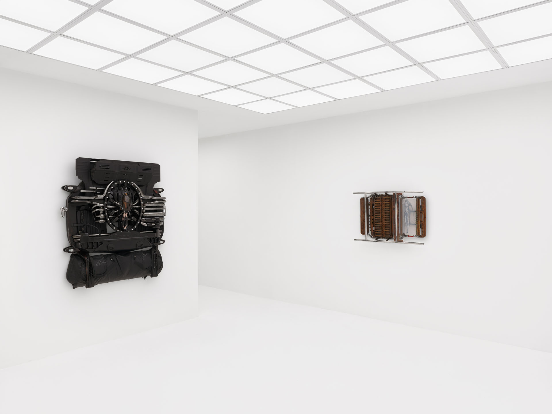 ENDO– by Taylor Ashby Hawkins at ASHES/ASHES — A monumental wall-mounted sculpture assembled from disassembled automotive engine components—ribbed cylinder heads and finned cooling structures—arranged...