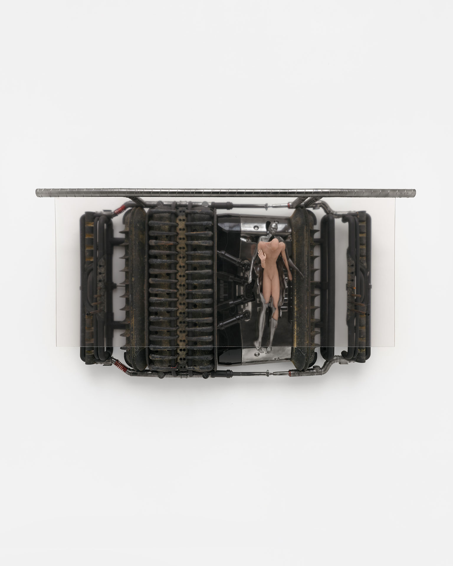 ENDO– by Taylor Ashby Hawkins at ASHES/ASHES — A wall-mounted sculptural assemblage presents a symmetrical arrangement of industrial engine components—ribbed aluminum or cast-metal cylinder heads and...