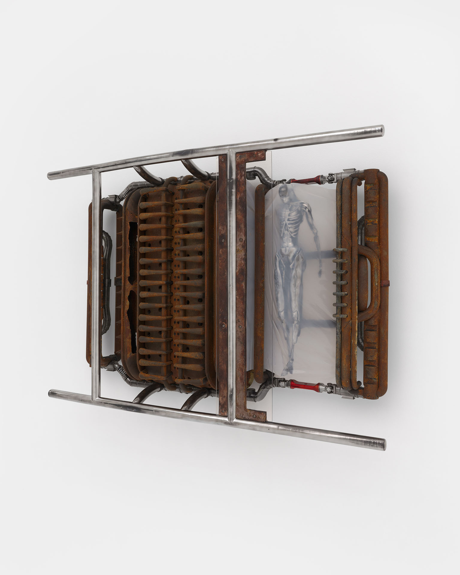 ENDO– by Taylor Ashby Hawkins at ASHES/ASHES — A wall-mounted mixed-media sculpture presents a sectioned industrial apparatus framed by steel tubing.