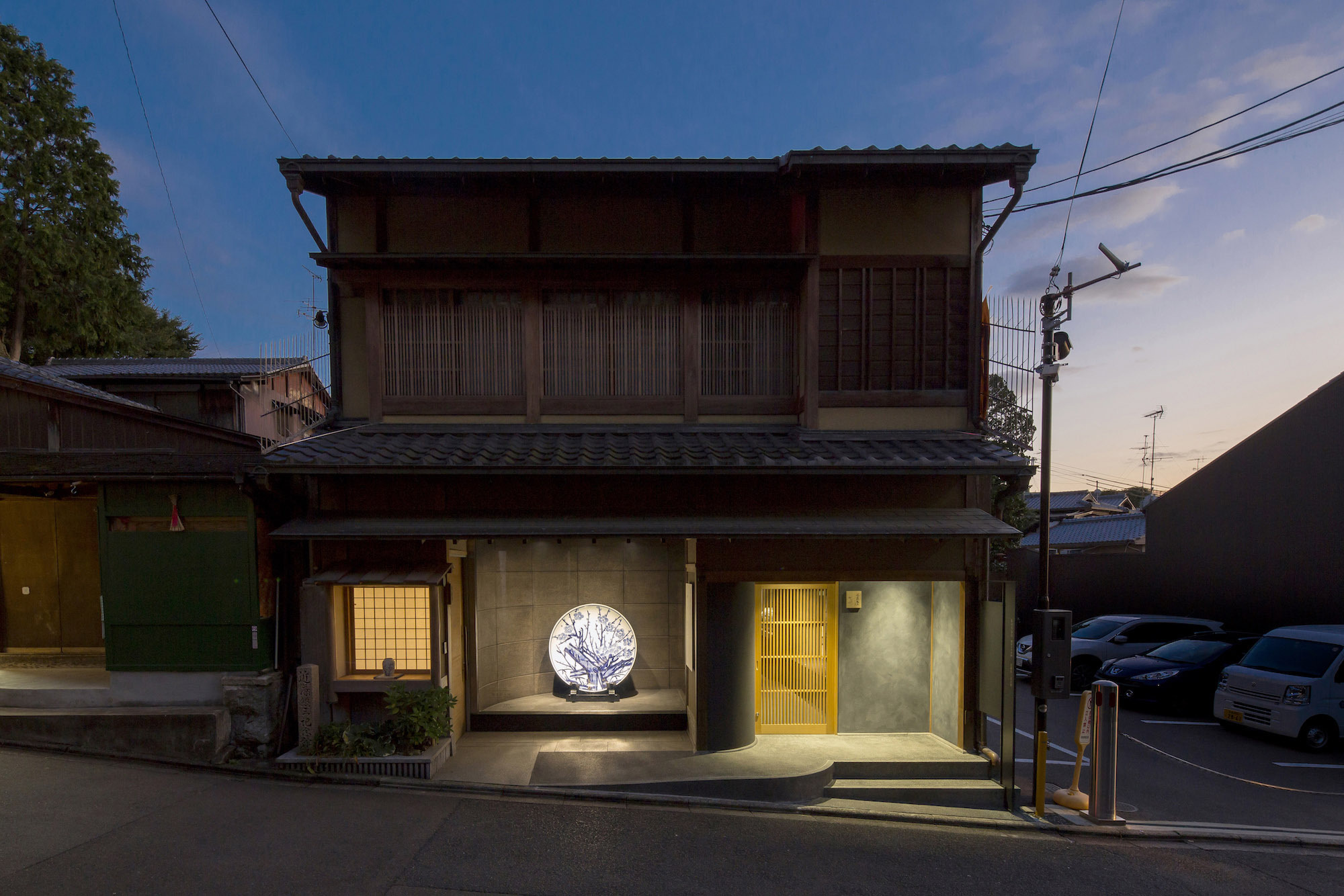 Kondo Museum in Kyoto by Mamiya Shinichi Design Studio — A renovated machiya storefront in Kyoto's Higashiyama district, photographed at dusk.